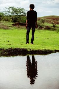 Full length rear view of man standing in lake