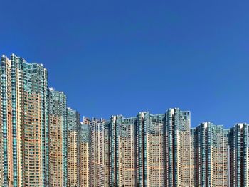 Low angle view of buildings against clear blue sky