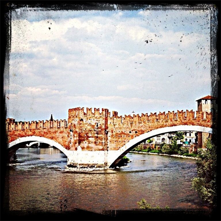 architecture, built structure, connection, arch, bridge - man made structure, arch bridge, bridge, building exterior, transfer print, river, sky, water, auto post production filter, engineering, transportation, city, travel destinations, cloud - sky, famous place, history