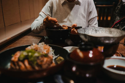 Midsection of man eating food