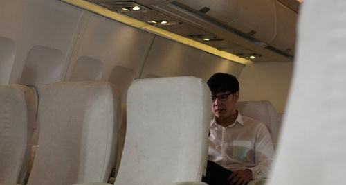 Portrait of man sitting in airplane