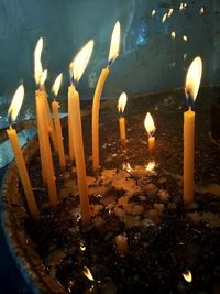 High angle view of lit candles in temple