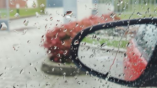 Close-up of wet car window in rainy season