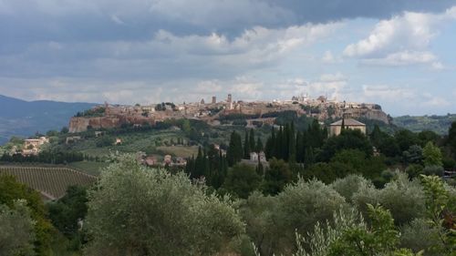 Panoramic view of town against cloudy sky