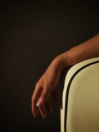 Close-up of hand over black background