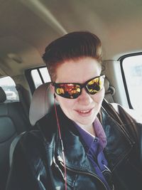 Portrait of smiling young woman in car