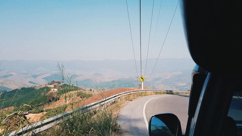 Scenic view of landscape seen through car windshield