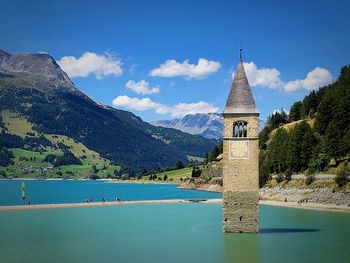 Scenic view of building and mountains against sky