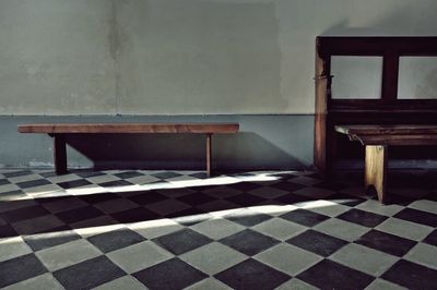 Empty chairs and table against wall at home