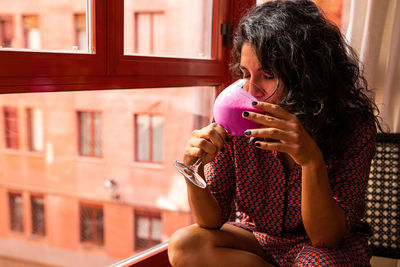 Woman sitting at window