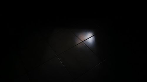 High angle view of illuminated tiled floor in building