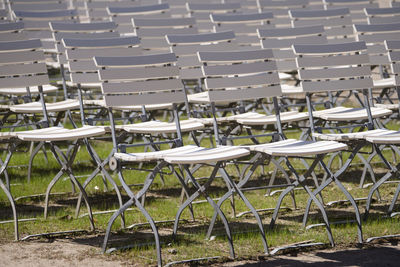 Empty chairs and tables in row