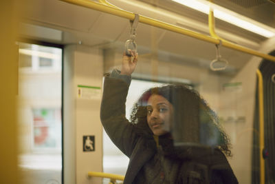 Woman in train looking at camera