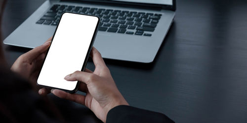 Low angle view of person using laptop on table