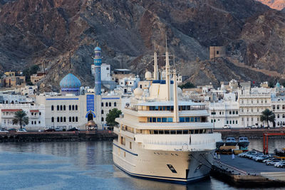 Sailboats moored on buildings in city