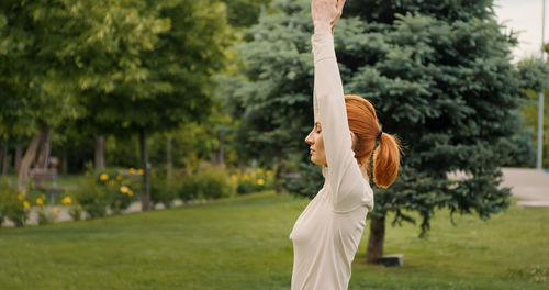 Fermale practises yoga in park. concept of fitness, healthy lifestyle. 