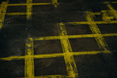 High angle view of yellow arrow symbol on road