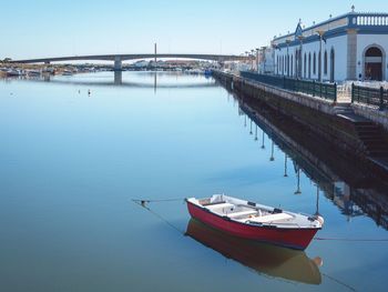 Boats moored in river against sky