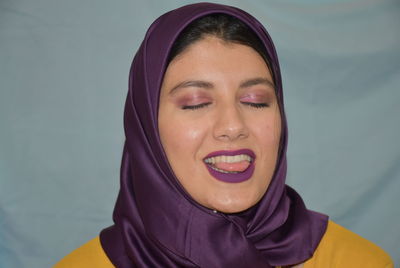 Portrait of a smiling young woman with eyes closed
