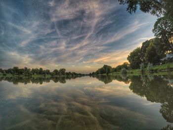 Scenic view of lake against sky at sunset