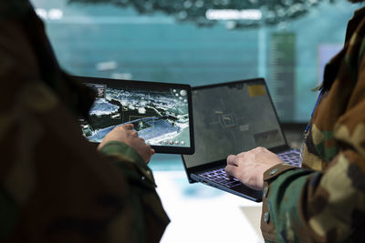 Midsection of man using laptop