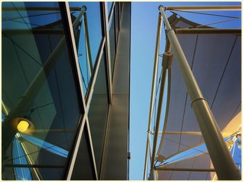 Low angle view of modern skyscraper against blue sky