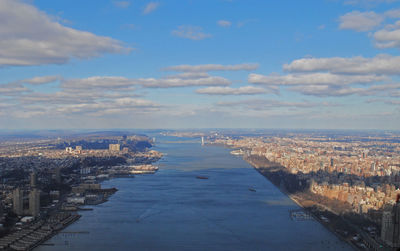 High angle view of buildings by city against sky