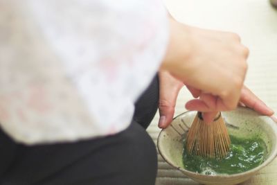 Close-up of woman making green tea