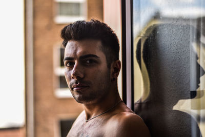 Portrait of shirtless man looking away