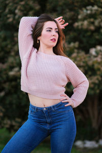 Portrait of a beautiful young woman standing outdoors