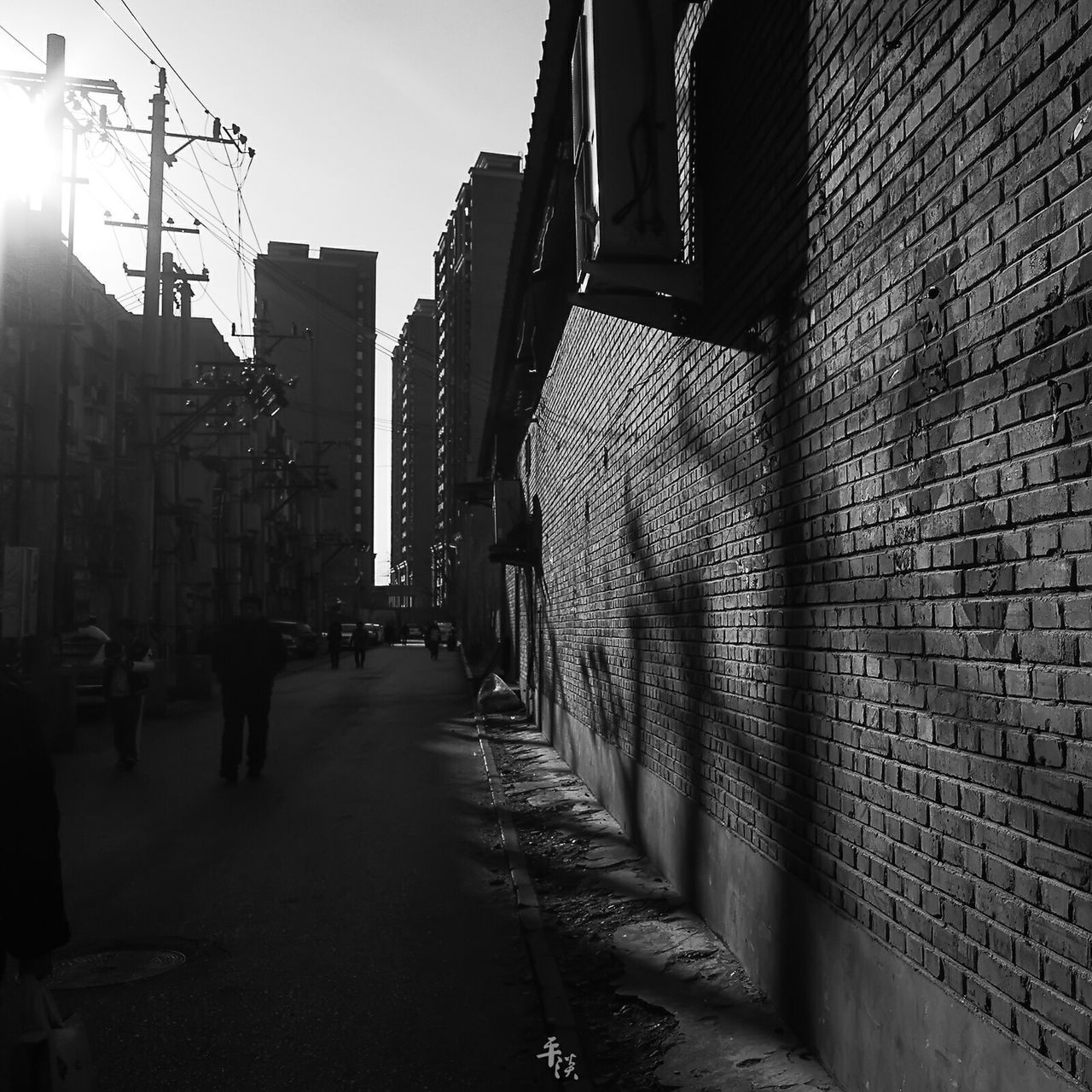 architecture, building exterior, built structure, city, street, the way forward, cobblestone, building, diminishing perspective, city life, city street, transportation, incidental people, residential building, vanishing point, sidewalk, footpath, residential structure, alley, outdoors