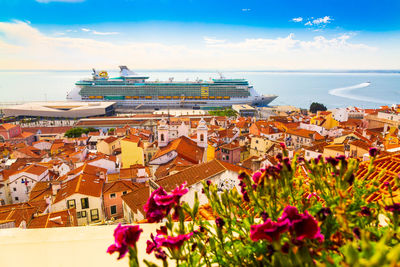 Scenic view of sea by buildings against sky