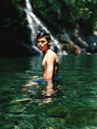 Portrait of shirtless man in water