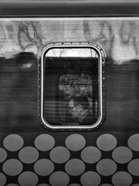 Reflection of woman on train window