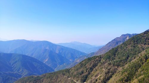 Scenic view of mountains against clear blue sky