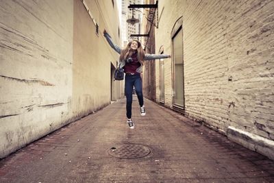 Cheerful girl in casual clothing jumping