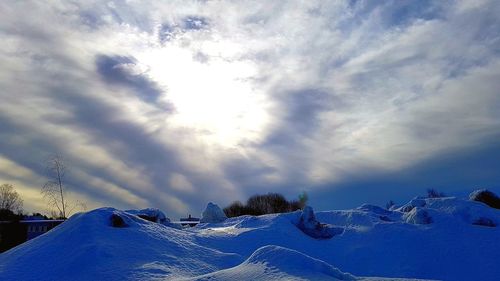 Snow covered land against sky