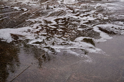 High angle view of wet snow covered land