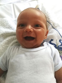 Portrait of cute baby boy on bed