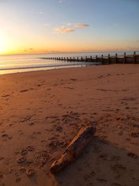 Scenic view of beach against sky during sunset