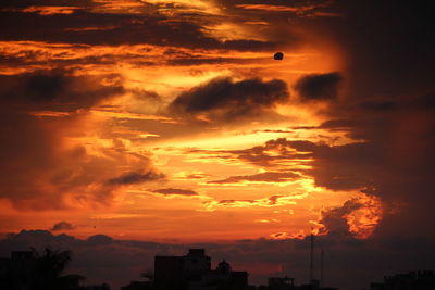 Low angle view of silhouette buildings against sky during sunset