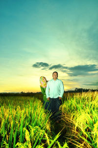 Portrait of couple standing on land against sky