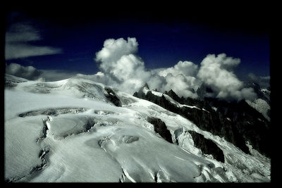 Scenic view of snow capped mountains against sky