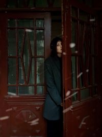 Woman standing against window