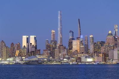 Illuminated city at waterfront