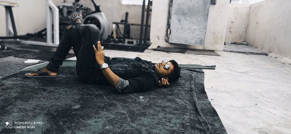 Young man lying down on floor