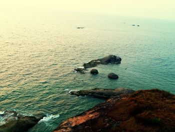 High angle view of rocks in sea against sky