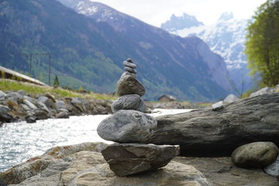 Stack of stones on rock against mountain