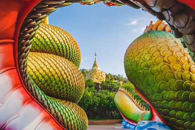 Big gold buddha and naga status in tham pha daen temple, the famous place