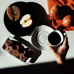 Cropped image of woman holding coffee cup